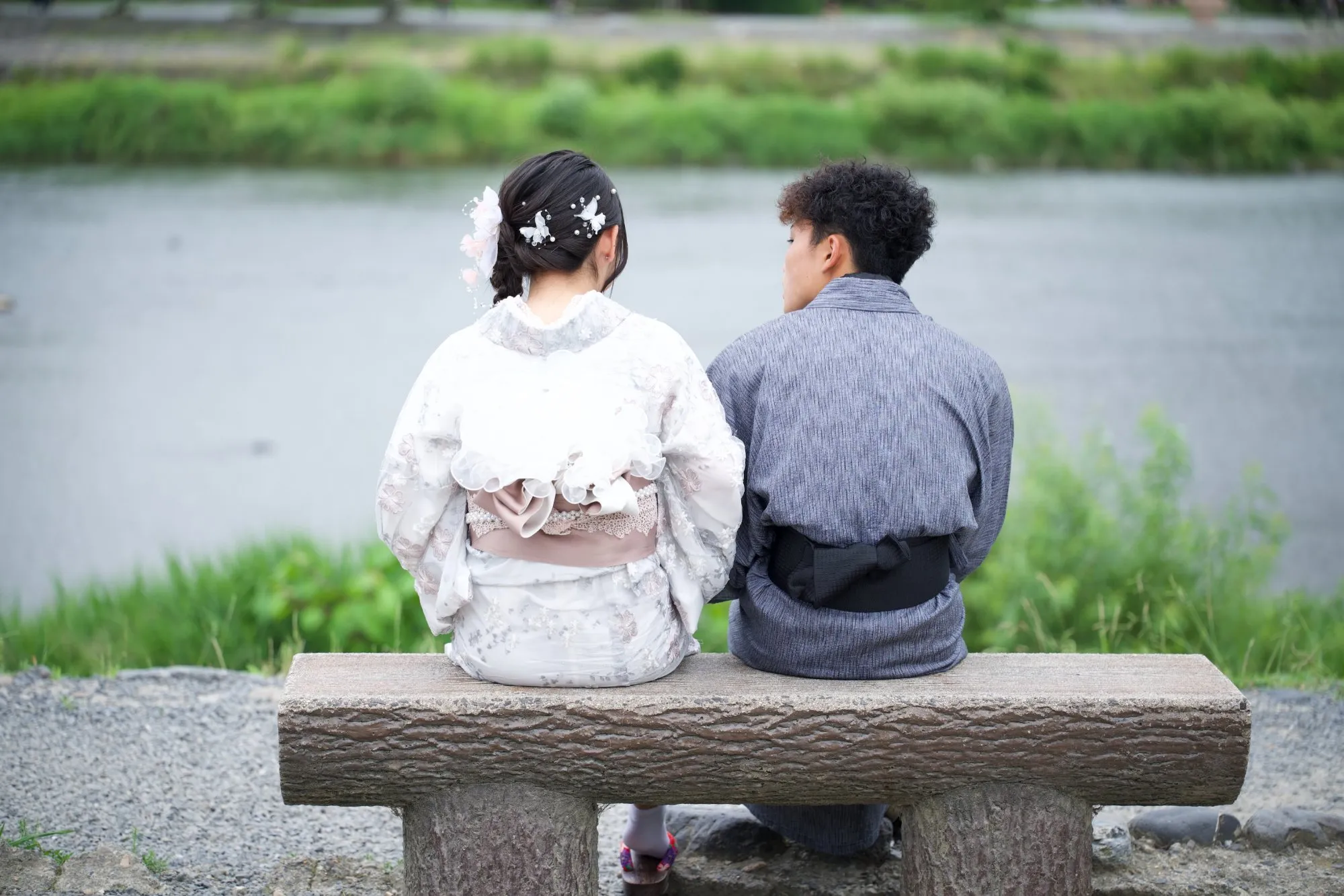 Couple in yukata by the Katsura River, Arashiyama, Japan — 2